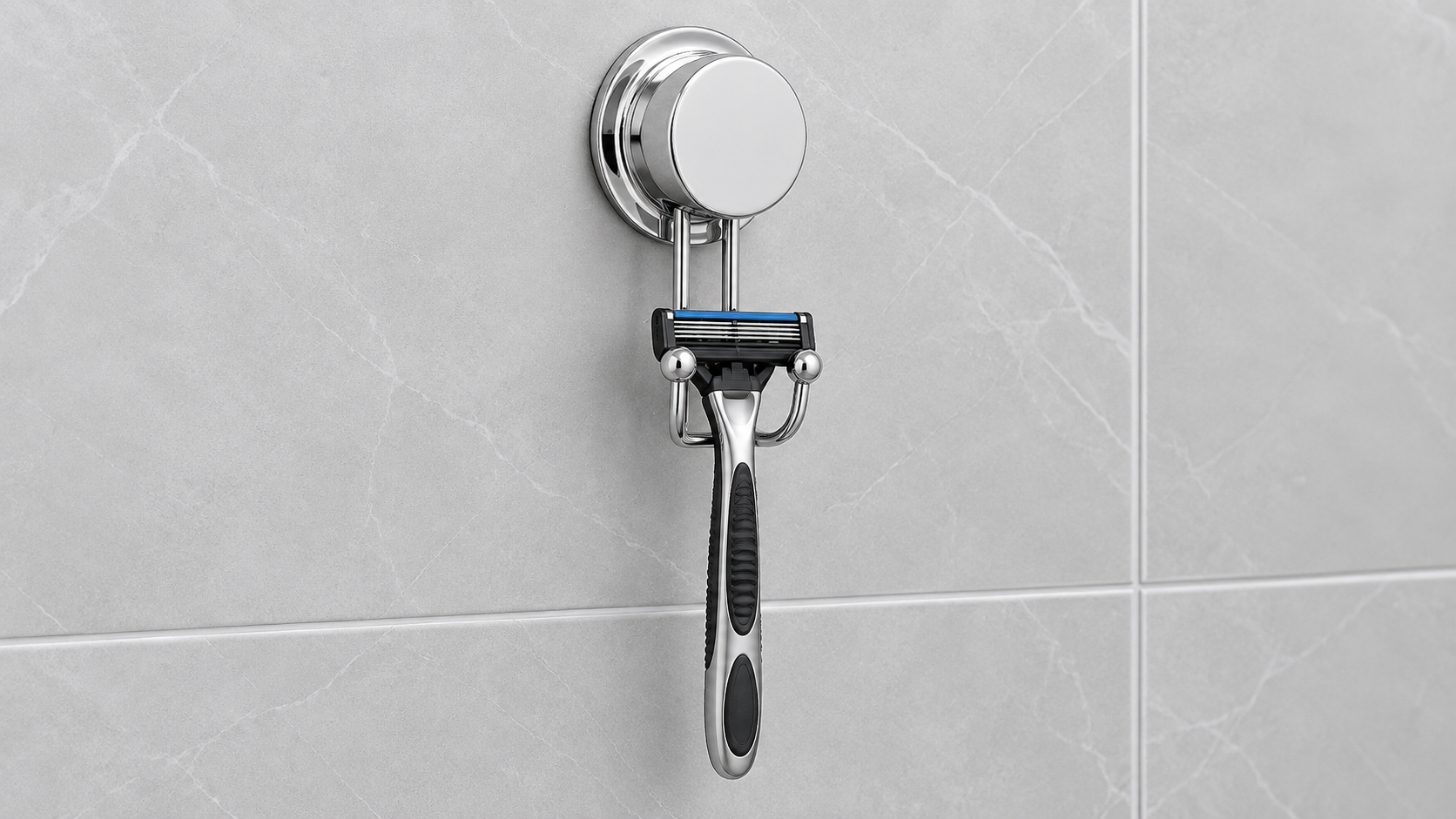 Custom chrome suction cup razor holder with U-shaped cradle on smooth tile.