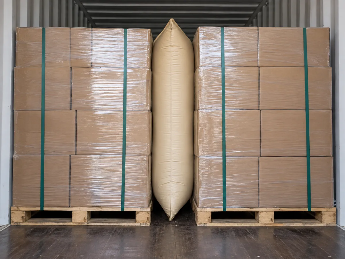 Close view of the dunnage bag contacting cartons and restraint surfaces, safe stable load arrangement.