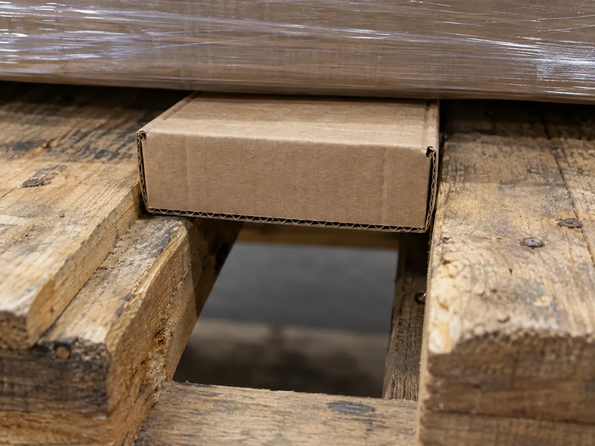small hardware cartons supported on a pallet deck for supplier qualification and buyer review