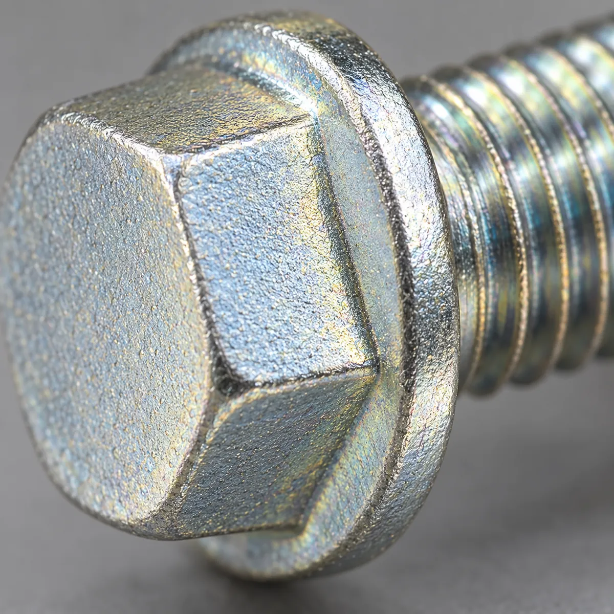 two plated metal fasteners in warm damp exposure trays, one zinc and one zinc-nickel appearance, without corrosion claims in a buyer-focused metal hardware sourcing review