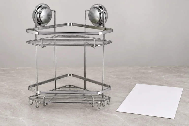 Two-tier chrome corner shower basket beside a version-controlled shipment handoff sheet