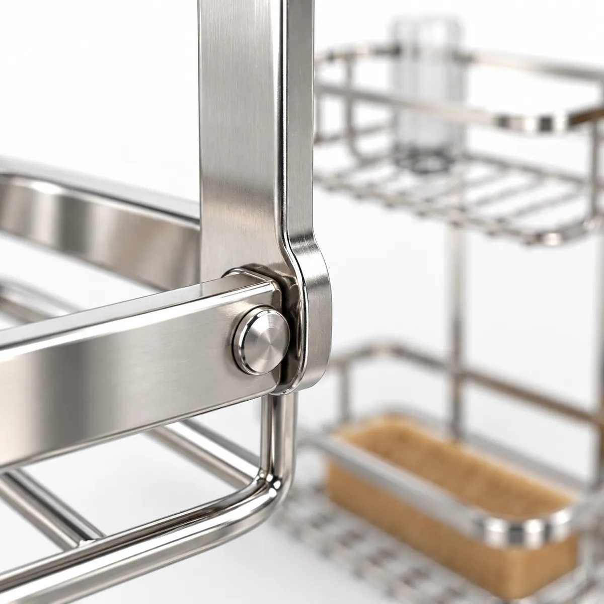 Close-up of a riveted pivot joint connecting overlapping metal tabs